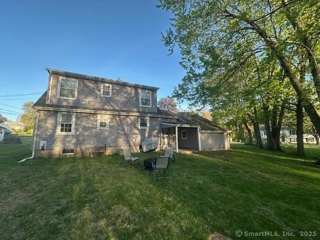 back of property featuring a yard