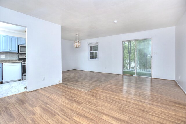 50 Greenhouse Rd Unit 17A, Bridgeport, CT 06606 - unfurnished living room featuring a chandelier and light wood finished floors