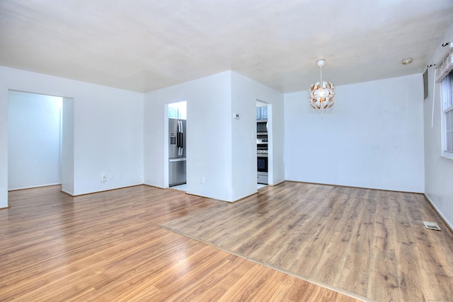 50 Greenhouse Rd Unit 17A, Bridgeport, CT 06606 - spare room featuring a chandelier and wood finished floors