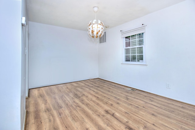 50 Greenhouse Rd Unit 17A, Bridgeport, CT 06606 - spare room with a chandelier and wood finished floors