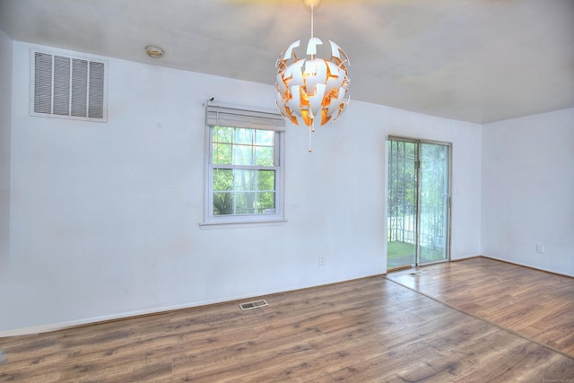 50 Greenhouse Rd Unit 17A, Bridgeport, CT 06606 - unfurnished room featuring a chandelier, wood finished floors, and a smoke detector