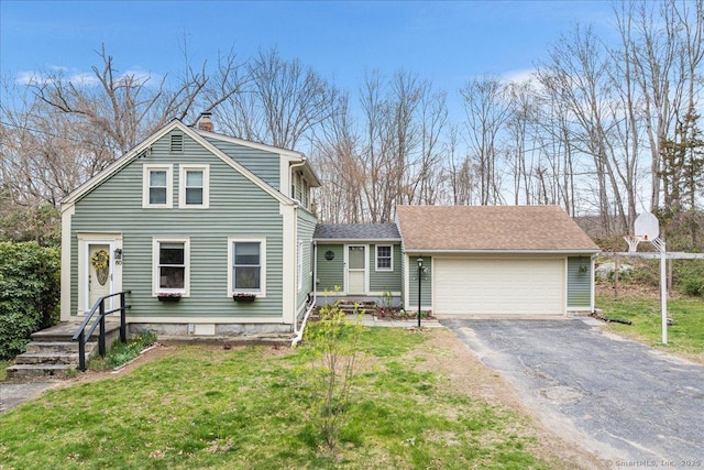 view of front of property featuring a garage, a front yard, driveway, and a chimney