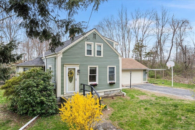 view of front facade featuring a garage, a shingled roof, and a front lawn