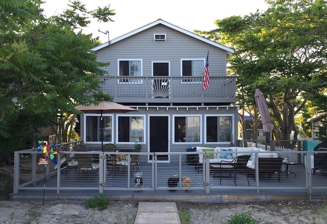 view of front of house featuring a wooden deck and a balcony