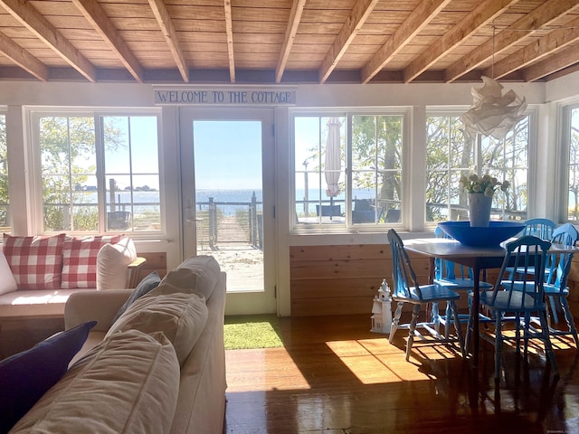 sunroom with wood-type flooring, a water view, beam ceiling, and wooden ceiling