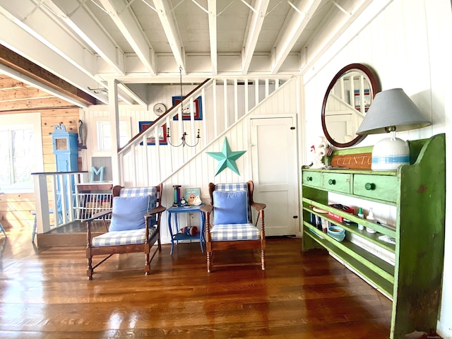 sitting room with stairs and wood finished floors