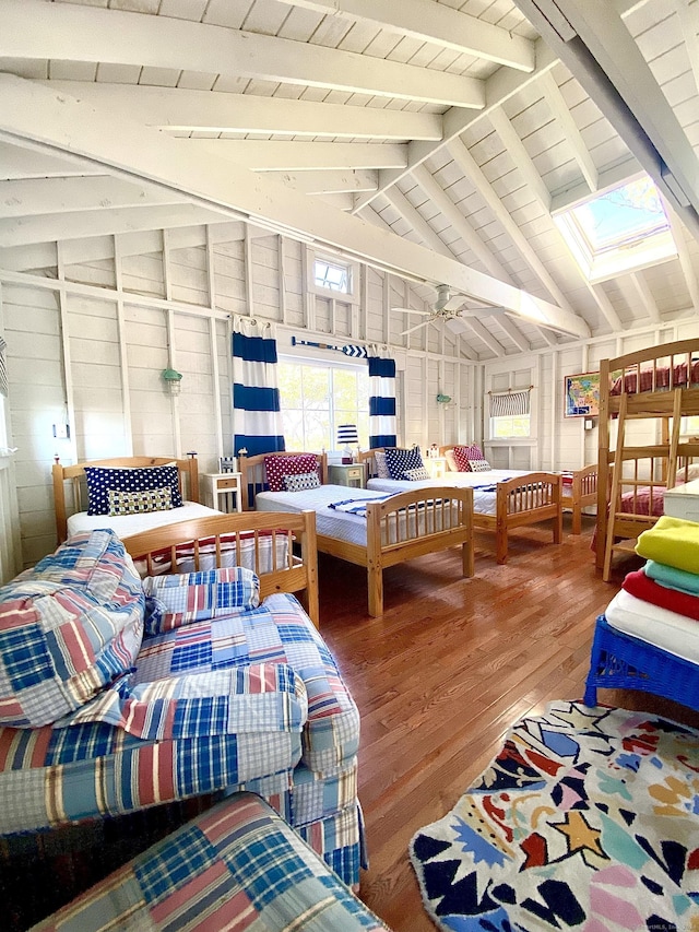 bedroom featuring wood finished floors, vaulted ceiling with skylight, and wooden ceiling