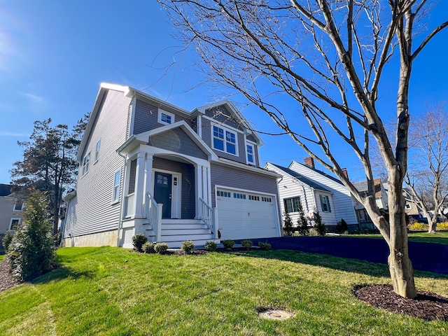view of front of house featuring a garage, a front lawn, and asphalt driveway
