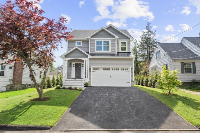 93 Wyoming St, Stratford, CT 06614 - view of front of home with driveway, a standing seam roof, a front lawn, a garage, and metal roof