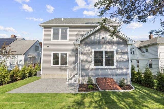 93 Wyoming St, Stratford, CT 06614 - back of house featuring a lawn and a patio area