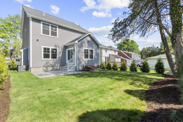 93 Wyoming St, Stratford, CT 06614 - rear view of property featuring central AC unit, a patio, a yard, and entry steps