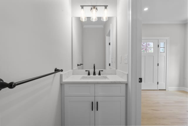 93 Wyoming St, Stratford, CT 06614 - bathroom with ornamental molding, wood finished floors, vanity, and baseboards