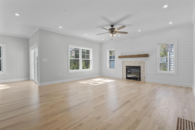 93 Wyoming St, Stratford, CT 06614 - unfurnished living room with ornamental molding, ceiling fan, baseboards, light wood-style flooring, and a tiled fireplace