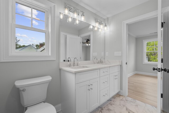93 Wyoming St, Stratford, CT 06614 - bathroom featuring toilet, double vanity, marble finish flooring, baseboards, and ceiling fan