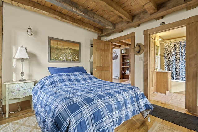 bedroom with beamed ceiling, a baseboard radiator, wood ceiling, and wood finished floors