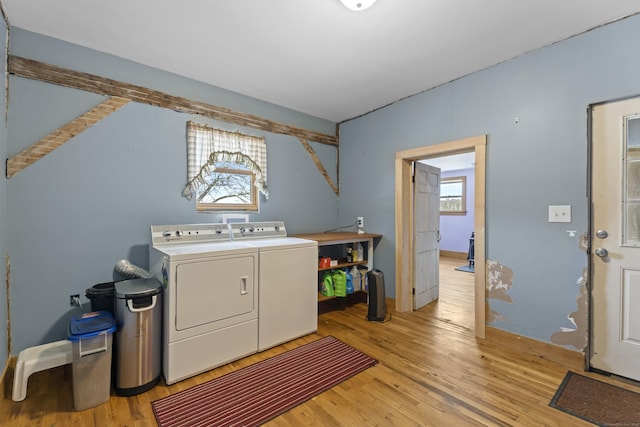 clothes washing area featuring laundry area, light wood-style flooring, and independent washer and dryer