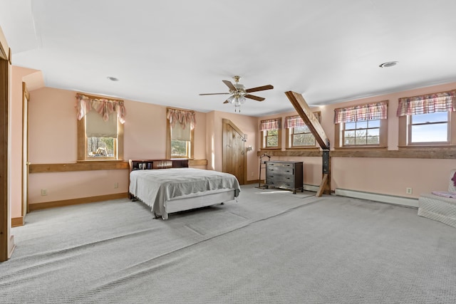 bedroom featuring a ceiling fan, baseboards, baseboard heating, and carpet