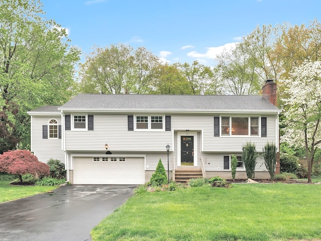 44 Belleview Dr, Derby, CT 06418 - split foyer home with a garage, driveway, a front yard, and a chimney