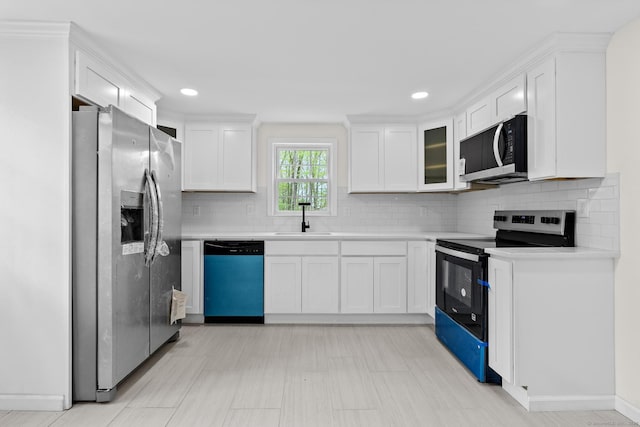kitchen featuring a sink, light countertops, white cabinets, and stainless steel appliances