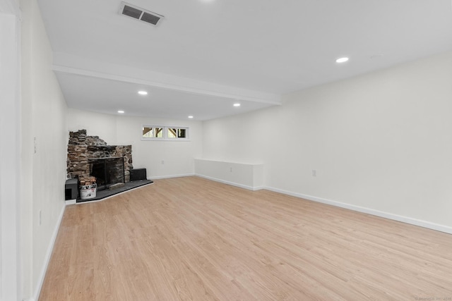 interior space with a fireplace, recessed lighting, light wood-style flooring, and visible vents
