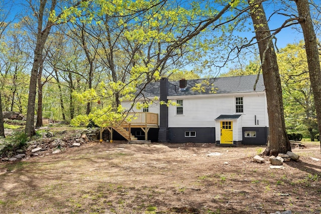 rear view of house with stairway and a deck
