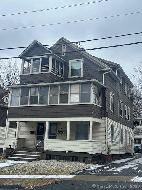 american foursquare style home featuring a porch