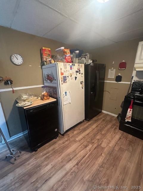 kitchen with light wood-style floors and black appliances