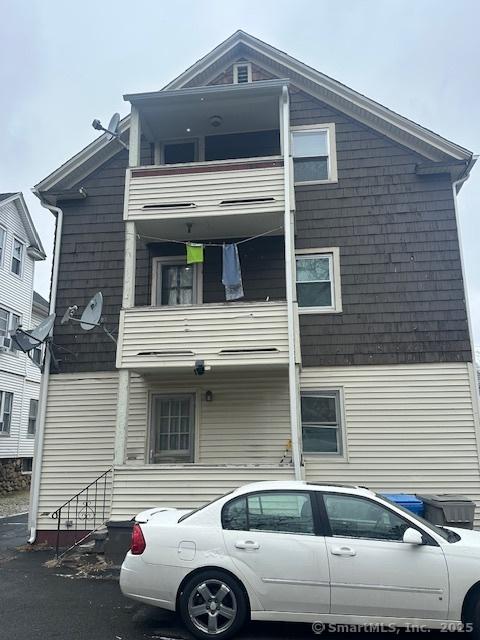 rear view of property featuring a balcony