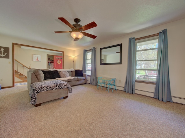living room with ceiling fan, light colored carpet, baseboards, and stairway