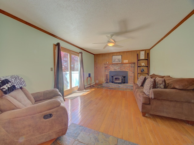 living room with ceiling fan, a textured ceiling, hardwood / wood-style floors, a baseboard radiator, and ornamental molding