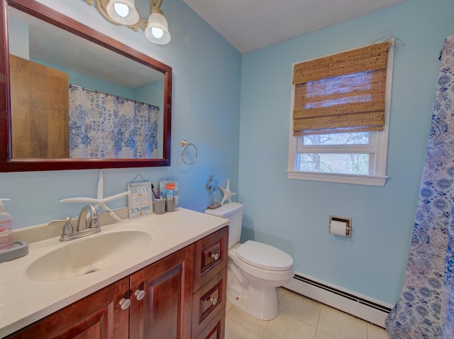 bathroom with tile patterned floors, baseboard heating, vanity, and toilet