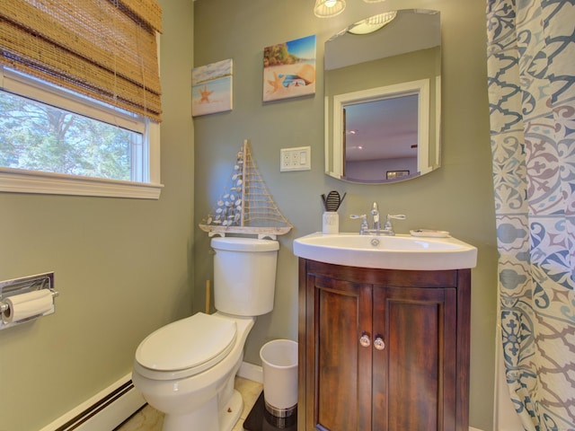 bathroom featuring vanity, baseboards, a baseboard heating unit, and toilet