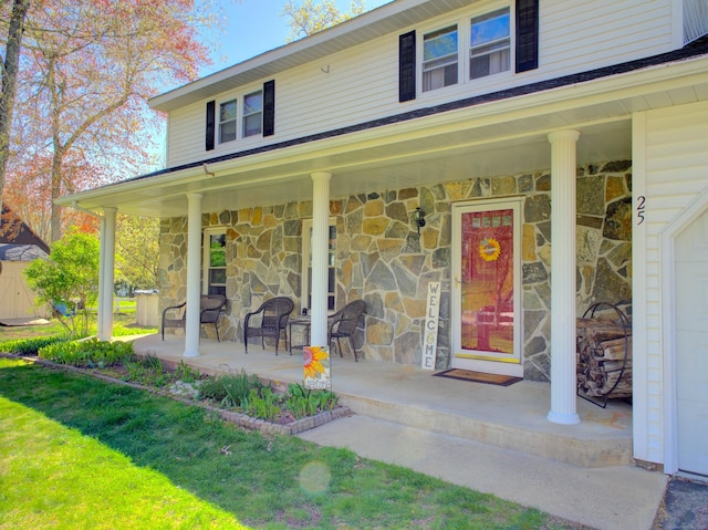 property entrance with a porch and stone siding
