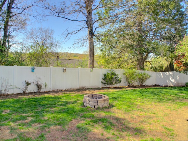 view of yard with a fenced backyard and an outdoor fire pit
