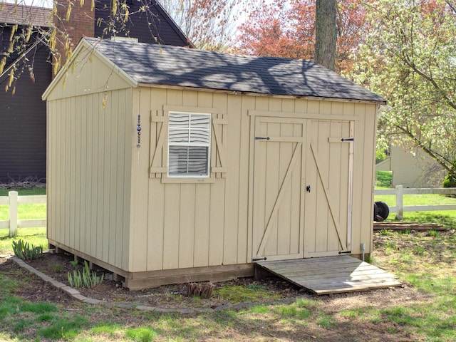 view of shed with fence