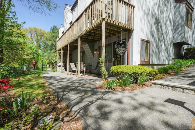 rear view of house with a patio and a deck