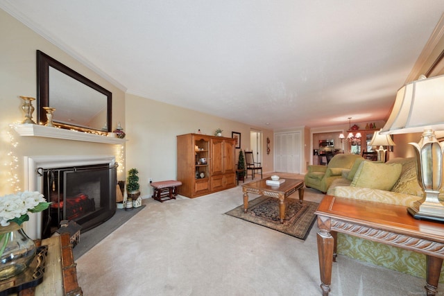 carpeted living area featuring crown molding, a fireplace with raised hearth, and a notable chandelier