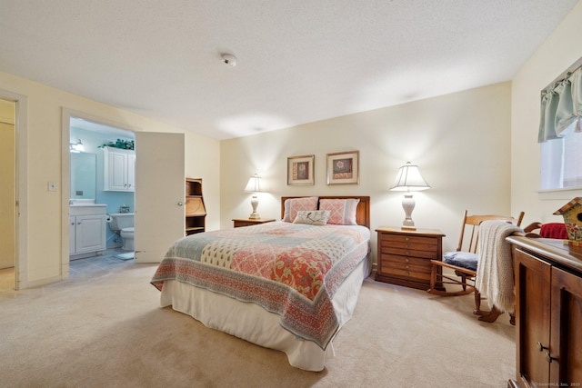 bedroom featuring ensuite bath and light colored carpet