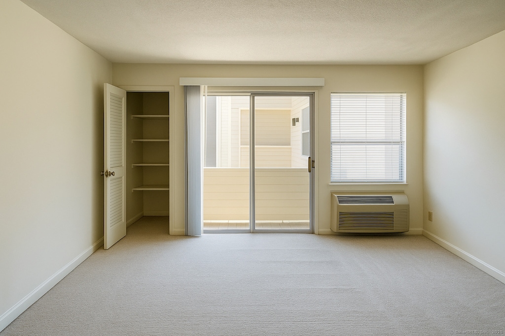 unfurnished bedroom with carpet flooring, baseboards, and multiple windows