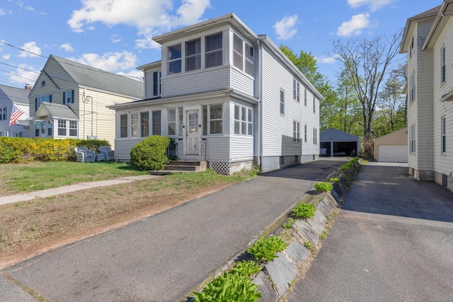 view of front of house featuring an outbuilding, entry steps, and a detached garage