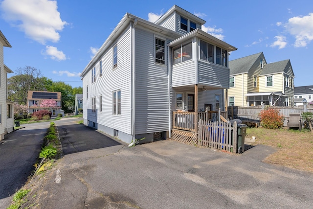 view of front of home featuring fence and a residential view