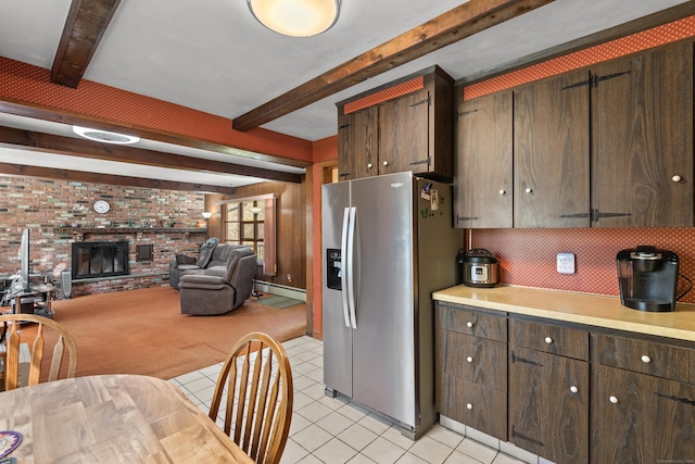 kitchen with dark brown cabinets, light carpet, beamed ceiling, stainless steel fridge, and a baseboard heating unit