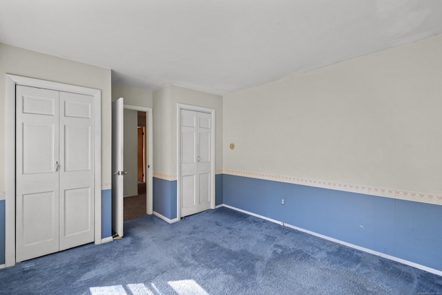 unfurnished bedroom with baseboards and carpet flooring