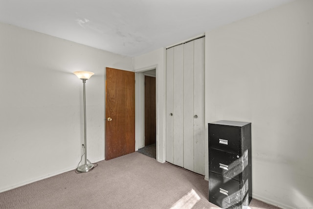 unfurnished bedroom featuring carpet floors and a closet