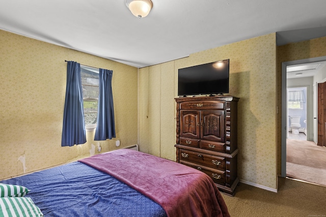 bedroom featuring wallpapered walls and carpet
