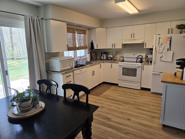 kitchen featuring a sink, white appliances, white cabinetry, wood finished floors, and under cabinet range hood