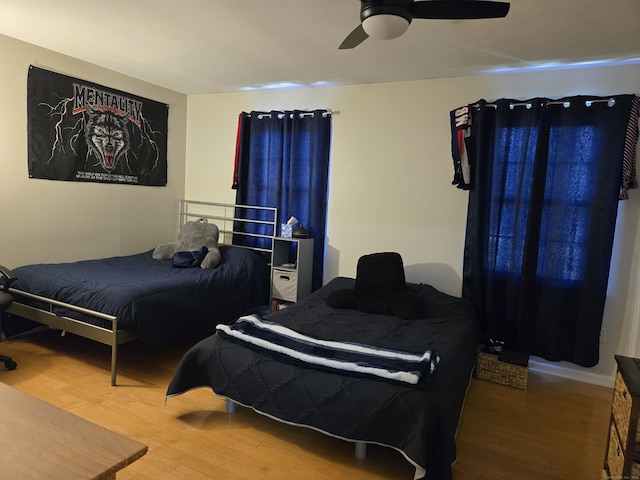 bedroom with a ceiling fan and wood finished floors