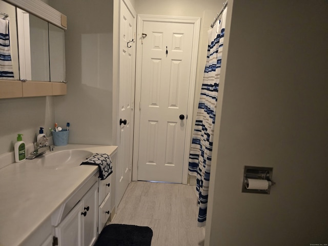 bathroom with vanity and wood finished floors