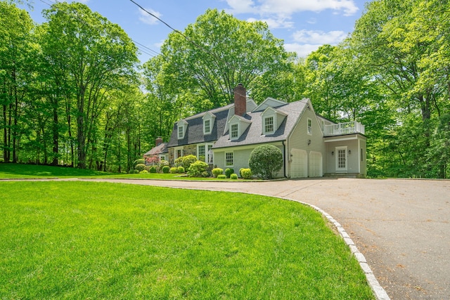 5 Dorr Rd, Darien, CT 06820 - view of front of home with asphalt driveway, a front lawn, a balcony, and a chimney