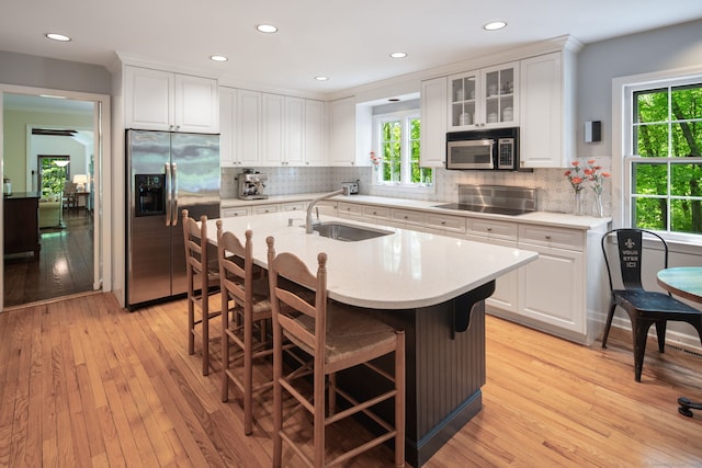 5 Dorr Rd, Darien, CT 06820 - kitchen featuring appliances with stainless steel finishes, a sink, light countertops, light wood-style floors, and recessed lighting